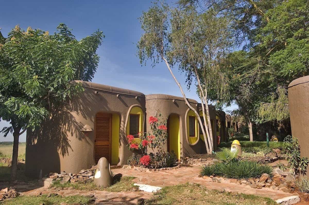 Rounded guest-room buildings and shaded garden at Mara Serena Safari Lodge