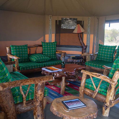 Mara Siligi Camp shared lounge with green cushions and wooden seating