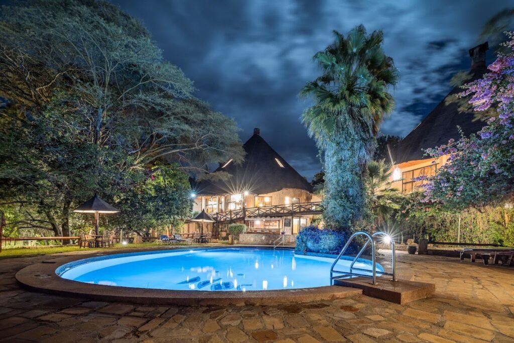 Mara Sopa Lodge communal pool and dining buildings in the evening