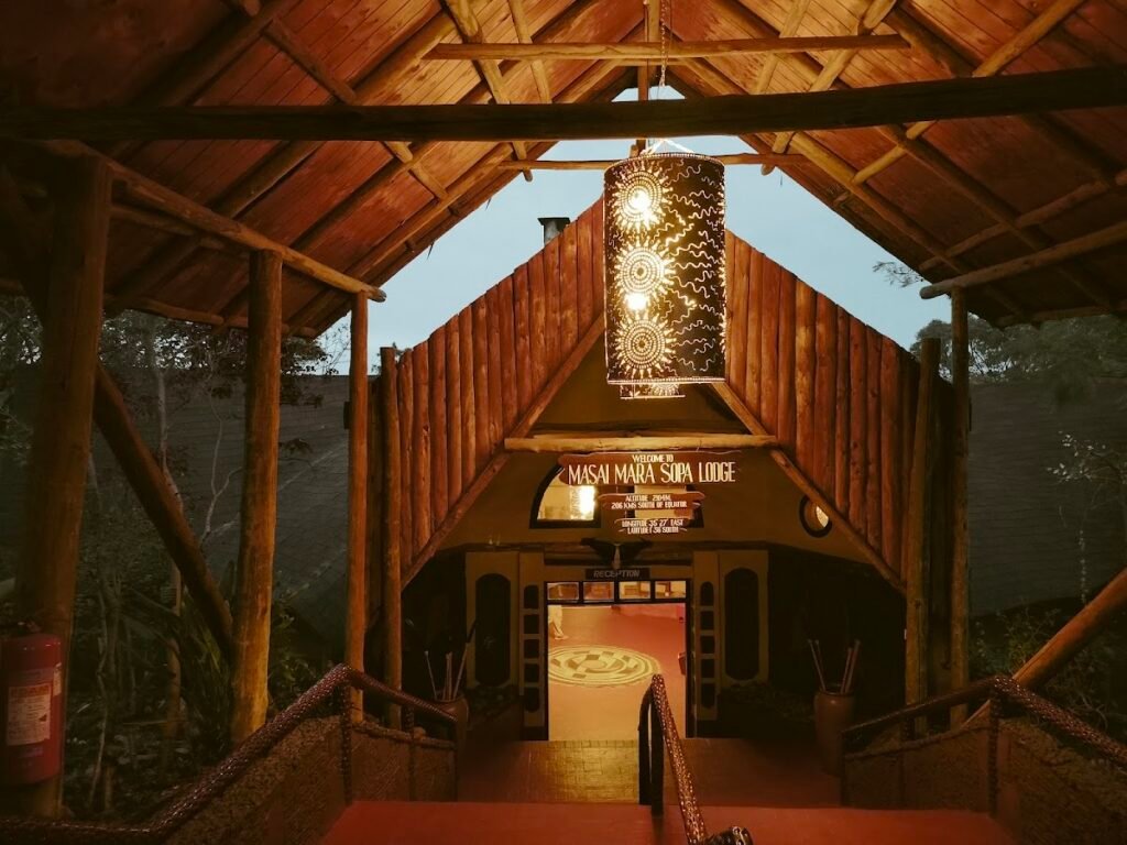 Maasai Mara lodges and camps 71 Mara Sopa Lodge timber entrance and reception walkway beneath hanging lanterns