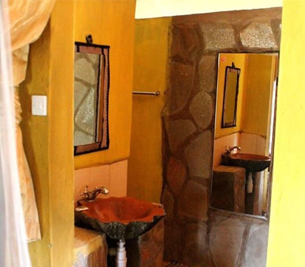 Mara Springs Safari Camp bathroom with stone washbasins and shower entrance