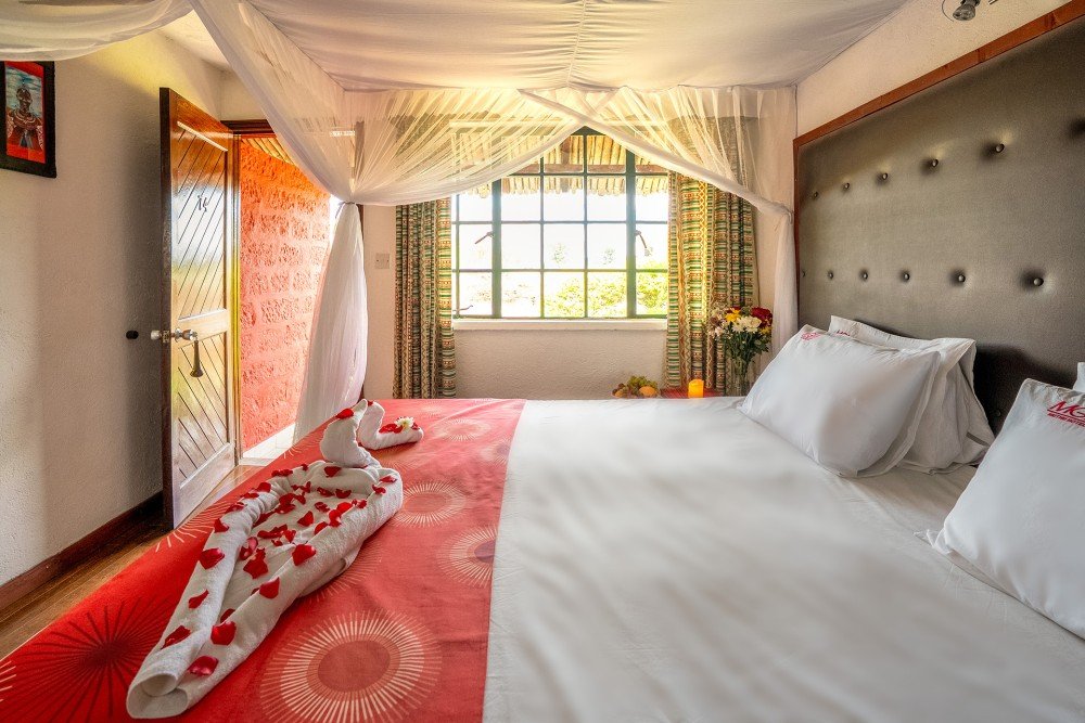 Muthu Mara River Lodge standard garden room with mosquito net and red bedspread