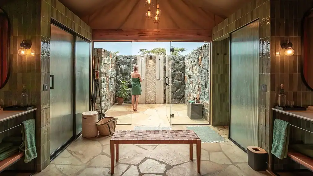 Naboisho Camp bathroom with twin wash areas and outdoor shower