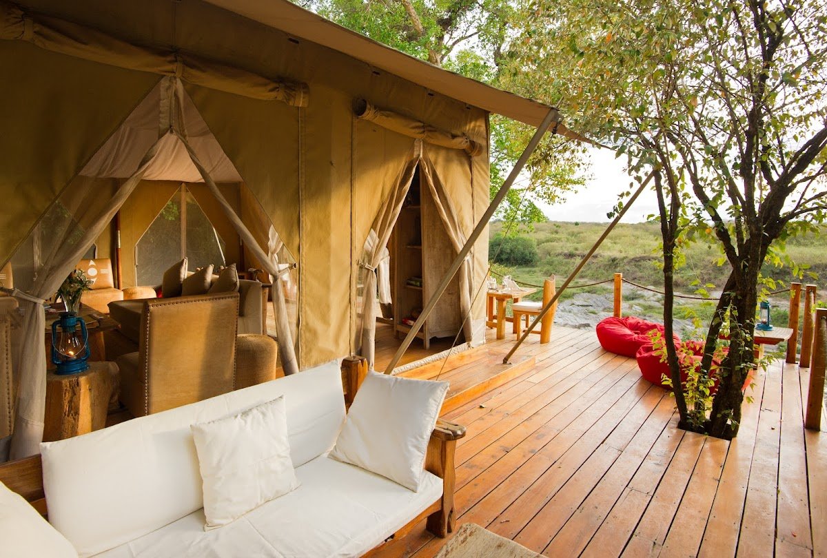 Naibor Camp canvas accommodation opening onto a shaded wooden veranda