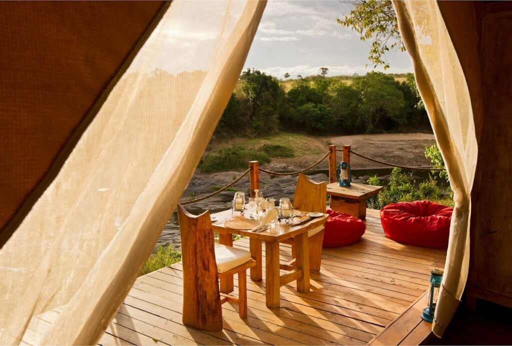 Naibor Camp veranda dining table and red floor cushions