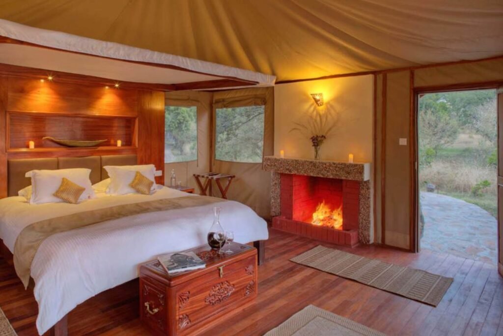 Naserian Mara Camp standard tent sitting area and fireplace