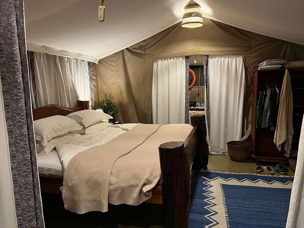 Bed and dressing area in an Offbeat Mara Camp ensuite tent