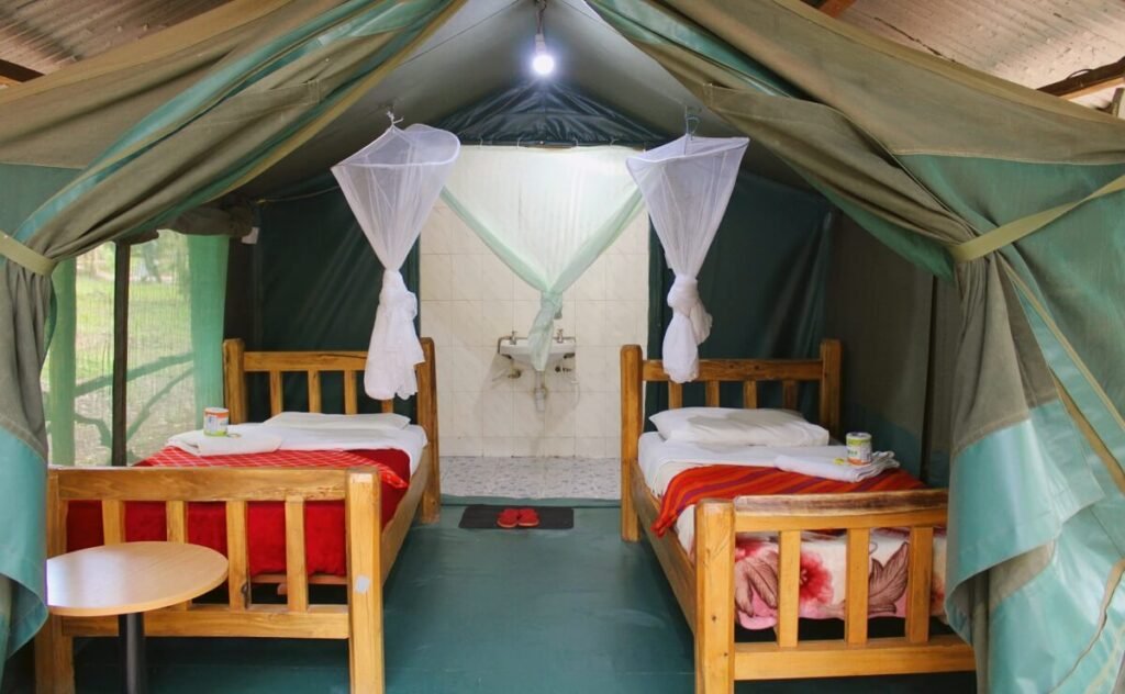 Olailepo Mara Camp timber twin beds, mosquito nets and attached wash area