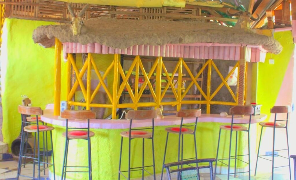 Olailepo Mara Camp bar with timber counter and tall chairs