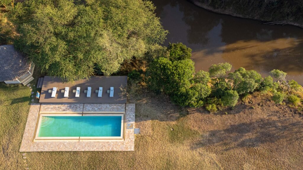 Maasai Mara lodges and camps 85 Olmarei House at Naretoi, with its swimming pool, riverside deck and garden