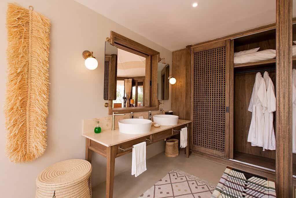 Wash basin, mirror and wardrobe area in a Nina Tent bathroom at Hemingways Ol Seki Mara