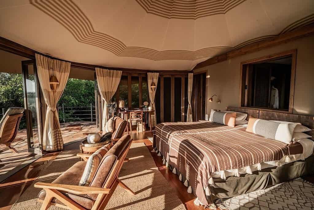 A Nina Tent bedroom and open veranda overlooking the bush at Hemingways Ol Seki Mara
