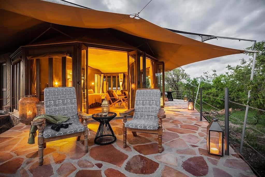 Maasai Mara lodges and camps 17 Hemingways Ol Seki Mara Nina Tent veranda with lanterns and canvas canopy