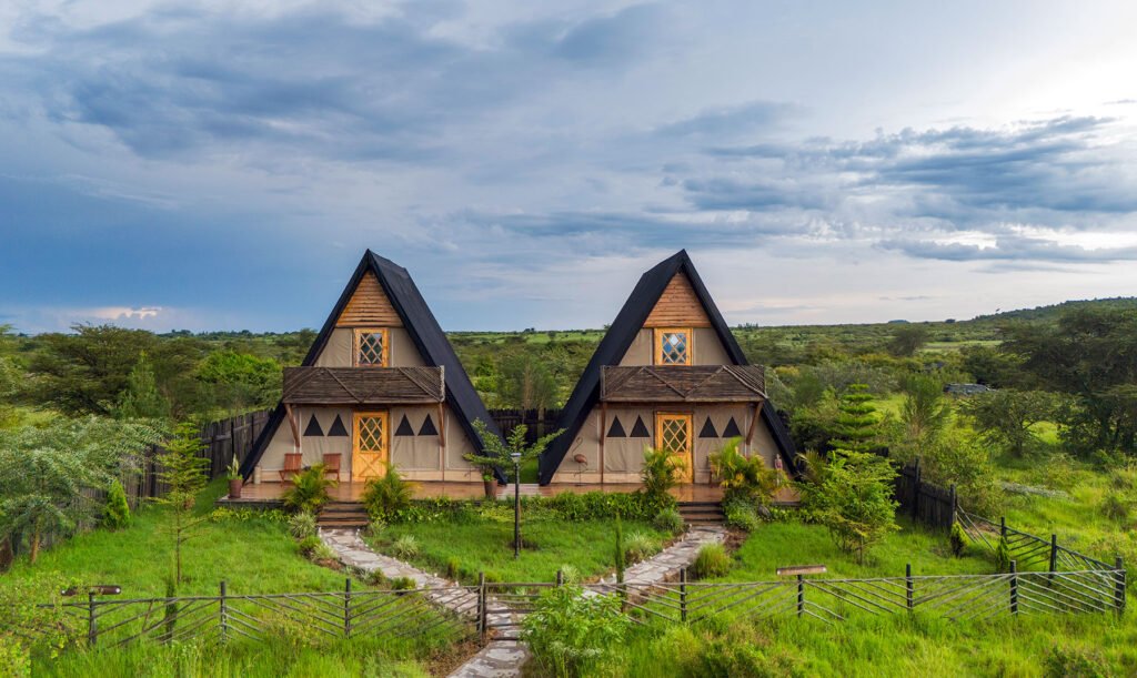 Osero Sopia River Camp A-frame accommodation with timber balconies and fenced garden paths
