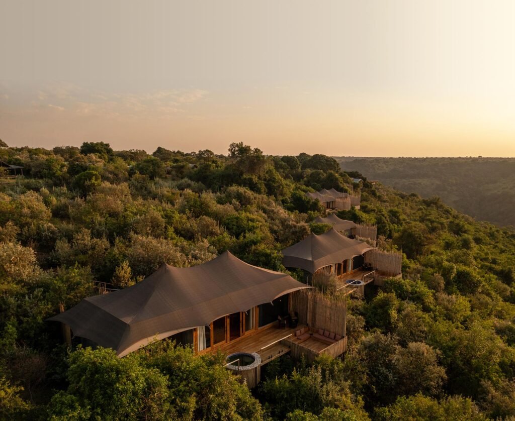 Maasai Mara lodges and camps 99 Pearl Mara tented suites with private decks among trees on the escarpment at sunset