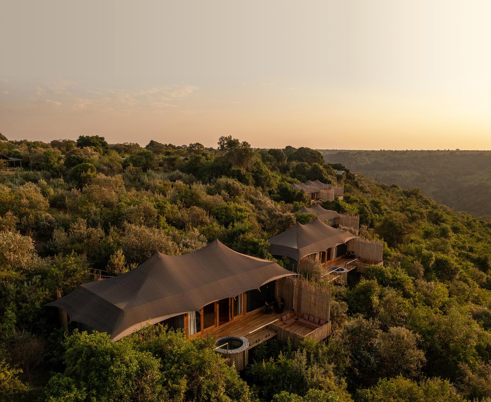 Pearl Mara tented suites with private decks among trees on the escarpment at sunset