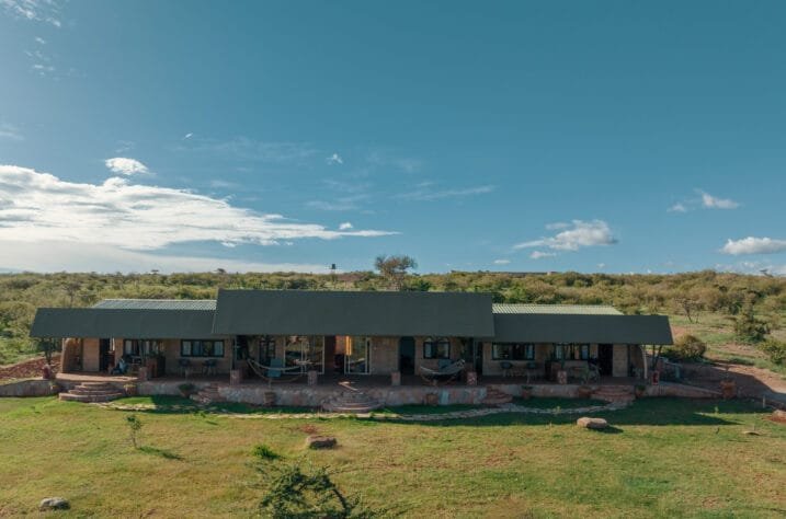 Porini Ol Kinyei Safari Cottages exterior with long veranda and savannah setting