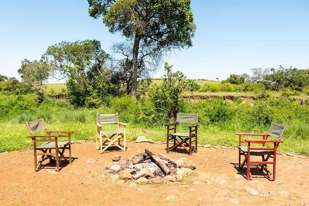 Campfire seating beside vegetation at Porini Lion Camp