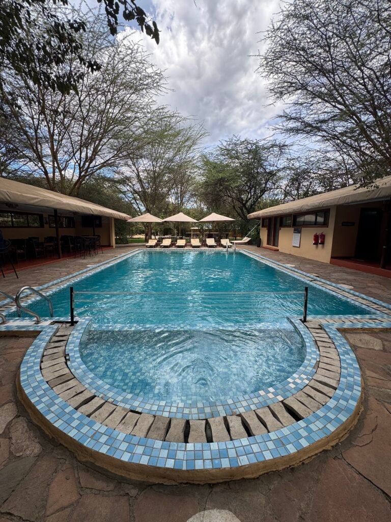 PrideInn Mara Camp outdoor swimming pool beside guest dining buildings