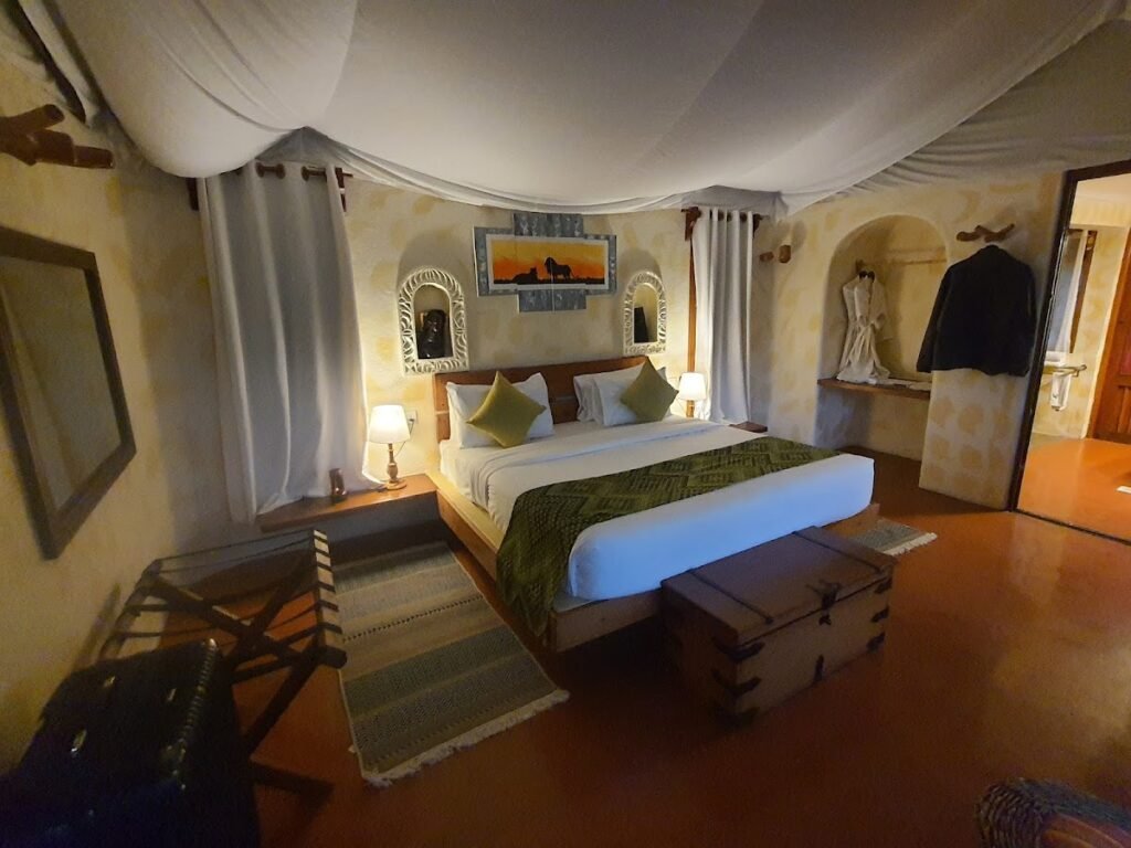 PrideInn Mara Camp double bedroom with canvas canopy and wooden chest