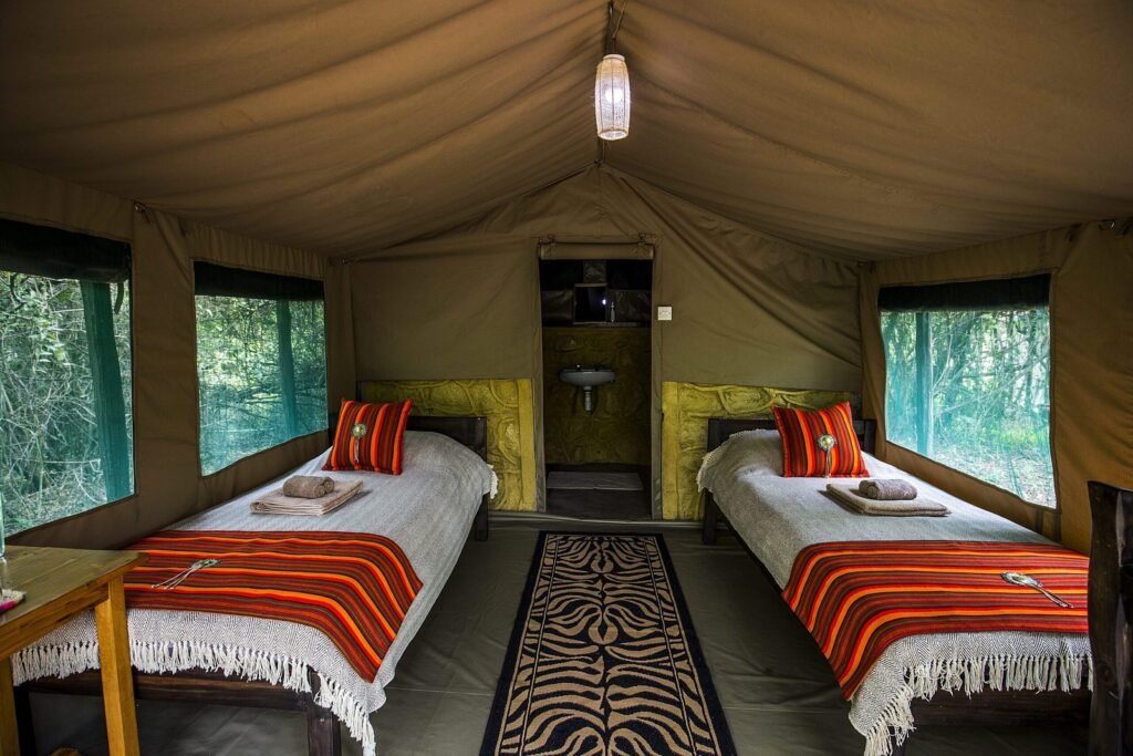 Mara Big Five Camp standard twin tent with striped bed covers and en-suite doorway