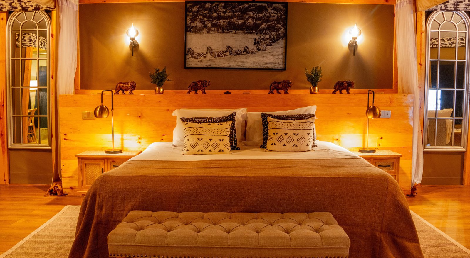 Lalashe Mara Ripoi tented suite with timber bed surround and wildlife artwork
