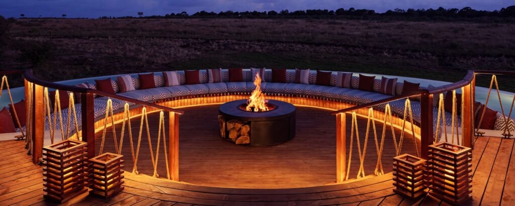 Maasai Mara lodges and camps 123 The Ritz-Carlton Maasai Mara Safari Camp Canopy firepit lounge with curved seating and timber deck