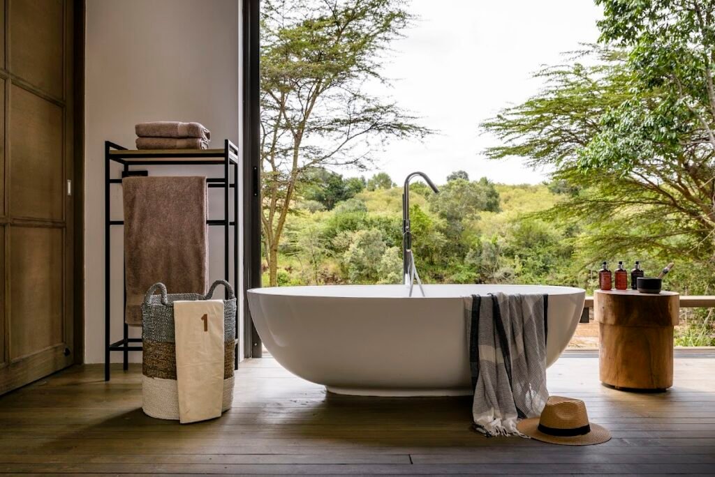 Sanctuary Olonana suite bathtub overlooking the wooded riverbank