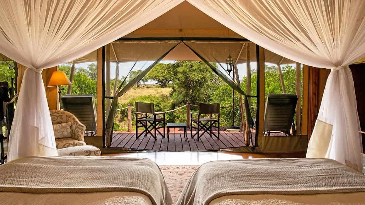 Twin beds and private veranda at Elewana Sand River Maasai Mara