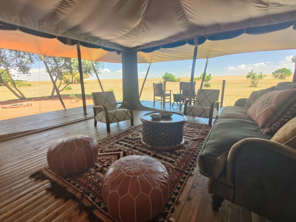 Saruni Wild canvas lounge with leather pouffes and views towards Lemek plains