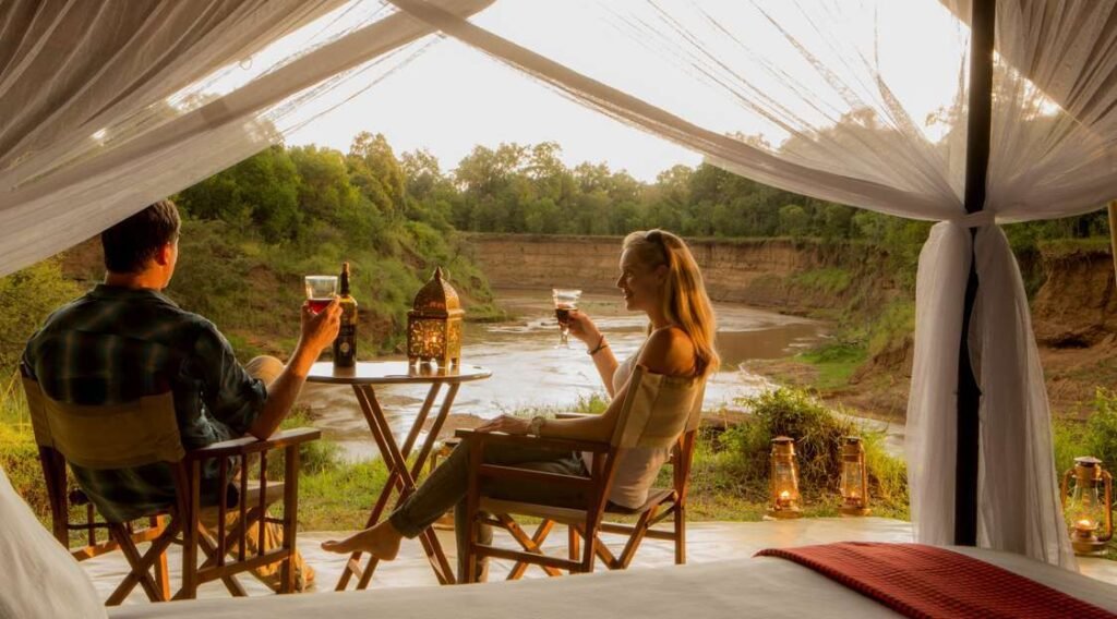Private riverside table framed by canvas at Sentinel Mara Camp