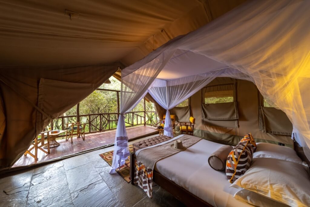 Maasai Mara lodges and camps 116 Sentrim Mara Lodge canvas tent bedroom with mosquito net and veranda