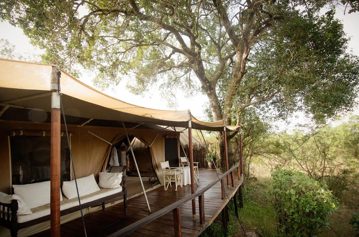 Serian The Original family canvas accommodation and timber deck beneath riverside trees