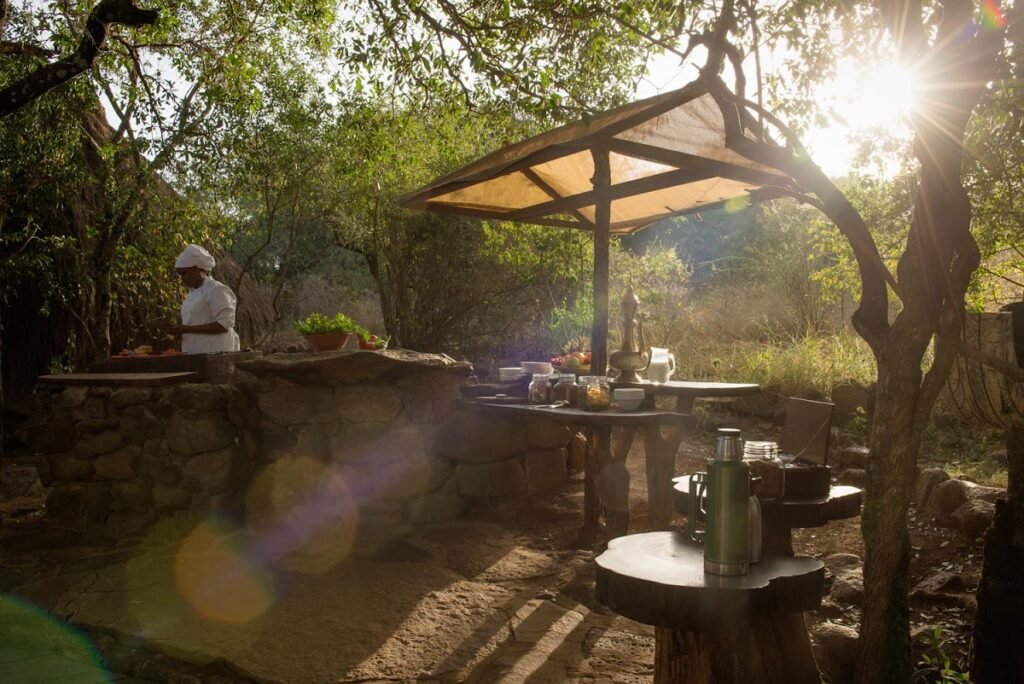 Outdoor breakfast preparation and shaded dining at Serian The Original
