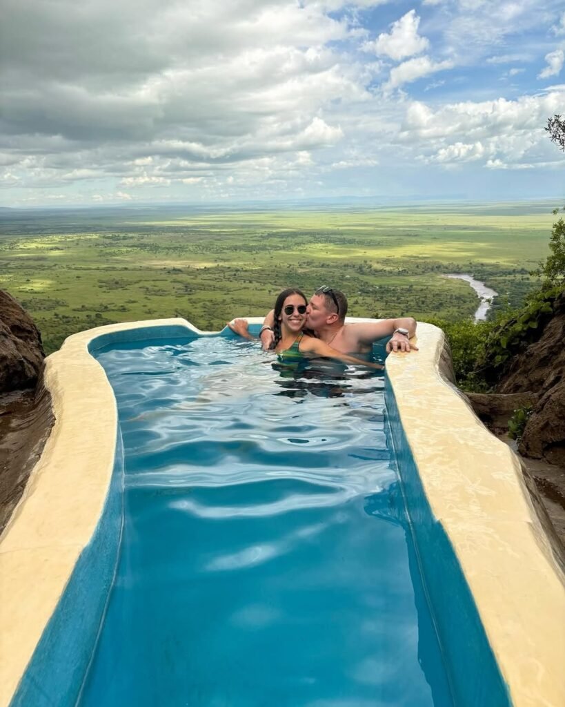 Guests in the shared plunge pool at Mara Siria overlooking the Mara River landscape