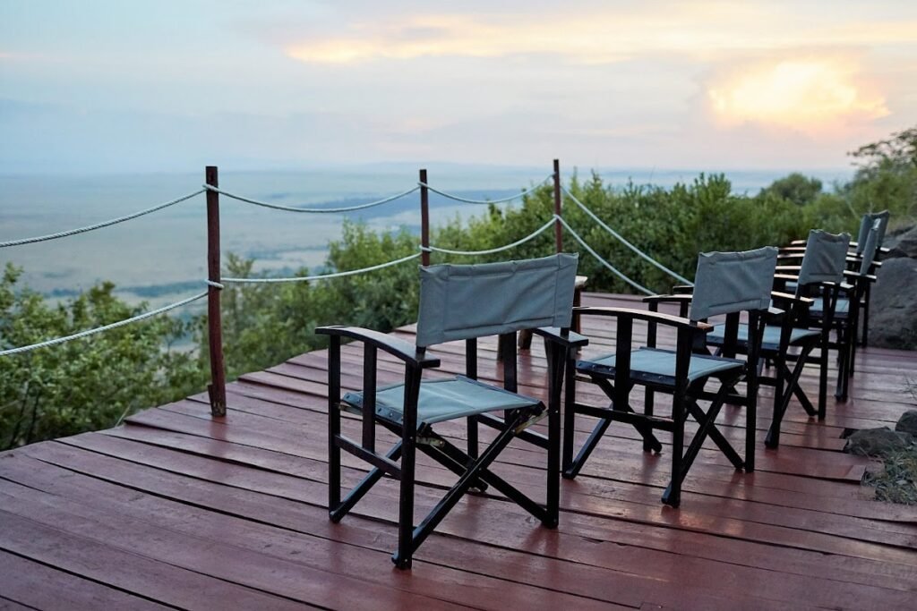 Mara Siria viewing deck with canvas chairs and rope railing above the plains
