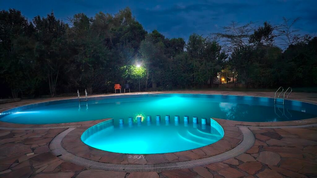 Talek Bush Camp shared swimming pool illuminated after dark