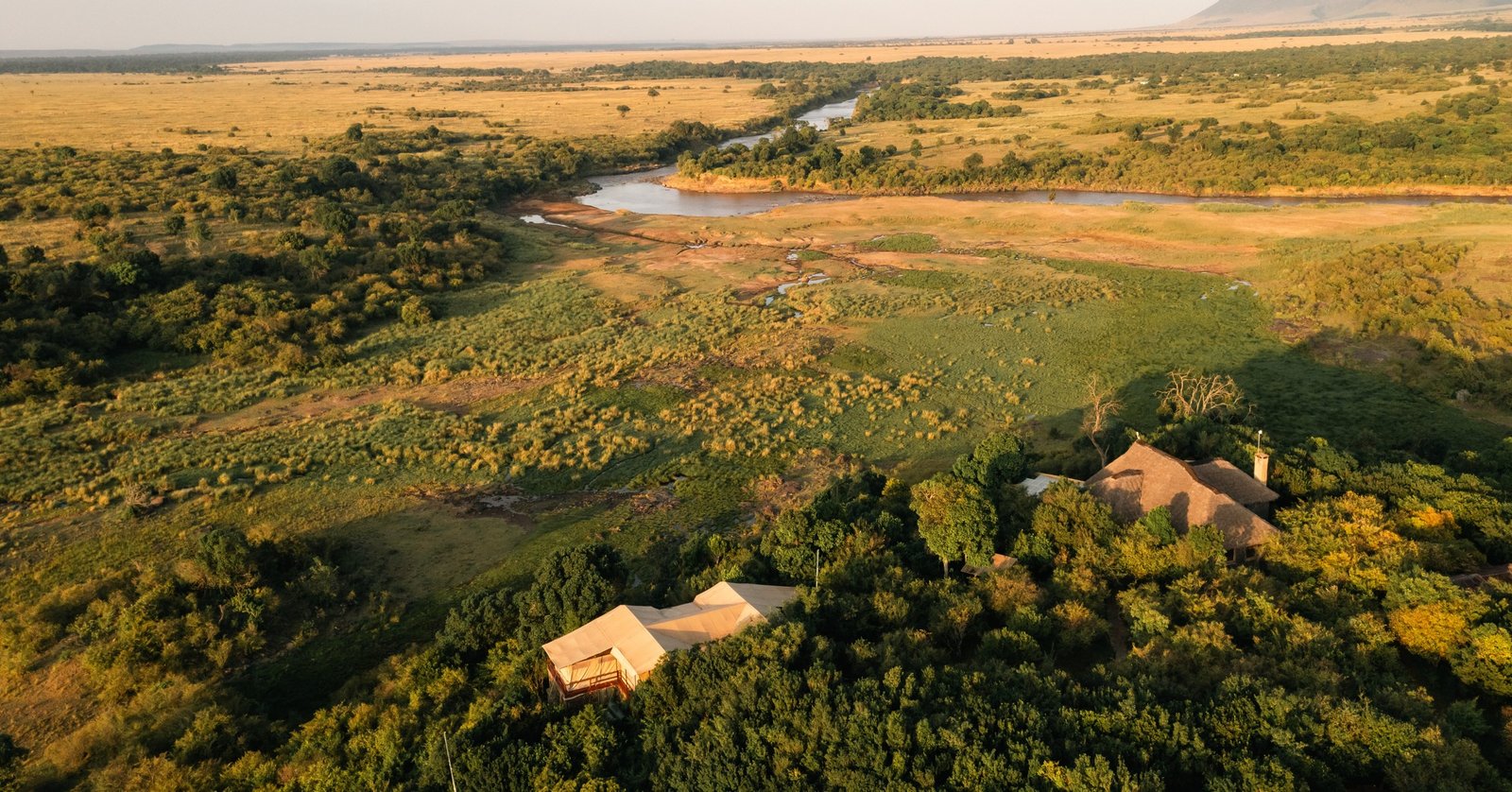 Tangulia Mara Camp guest areas and tents beside the open salt-lick landscape