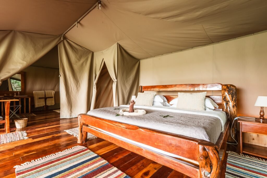Tangulia Mara Camp double bed inside a furnished canvas tent