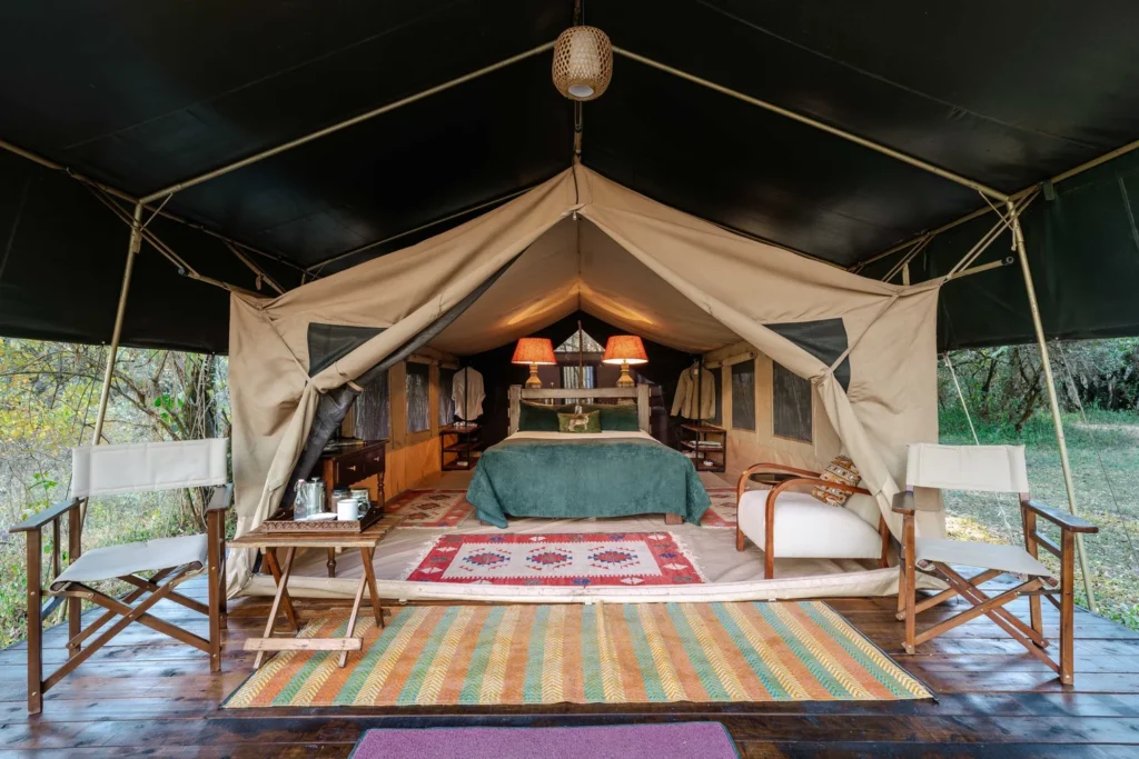Tor's Camp Mtoni double bed and canvas veranda seating on a wooden deck