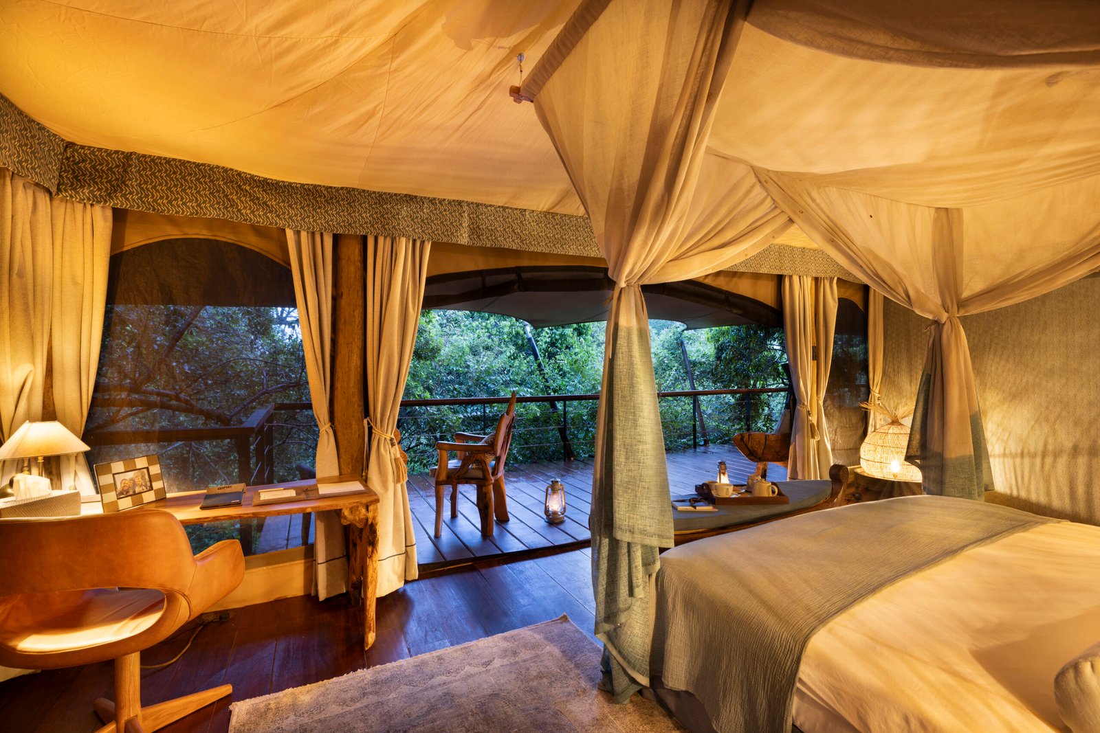 Mara Toto Tree Camp guest suite with netted bed and timber veranda within trees