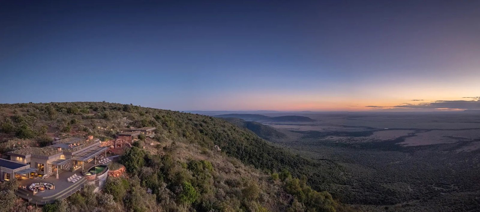 Wild Hill grass-roofed retreat and landscape at dusk